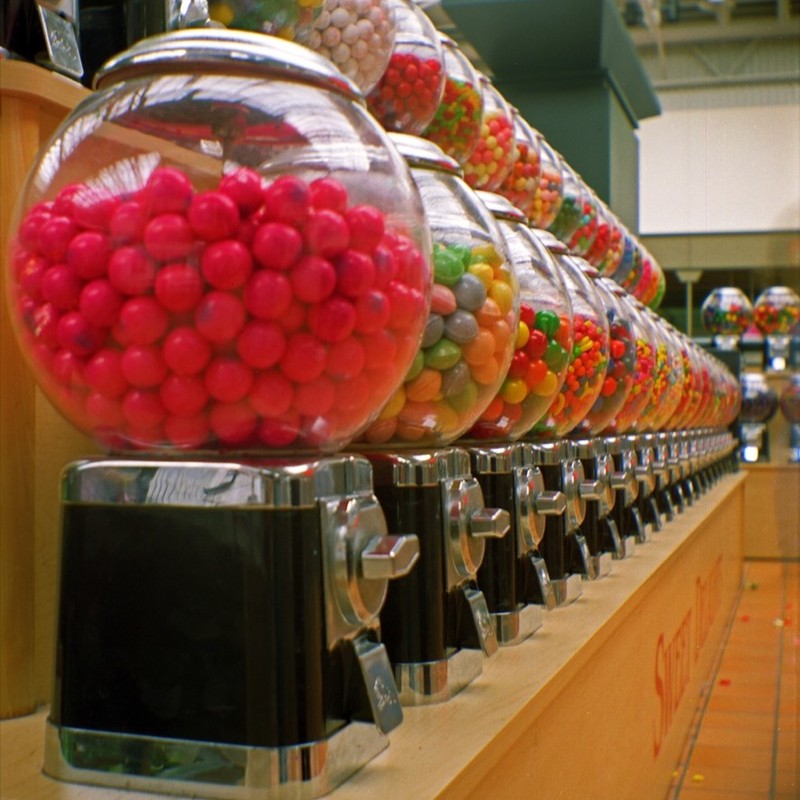 A row of coin-operated gumball machines. A row of coin-operated gumball machines.